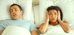 man keeps woman awake by snoring