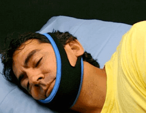 man wearing chin strap for snoring man wearing chin strap for snoring