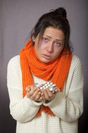 lady with a cold and medications