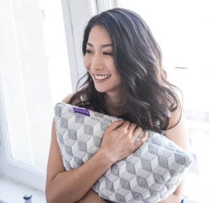 woman holding layla pillow