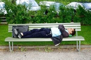 business man laying on bench