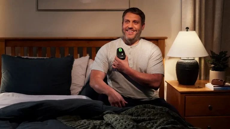 man sits in bed with inspire device activated (1)